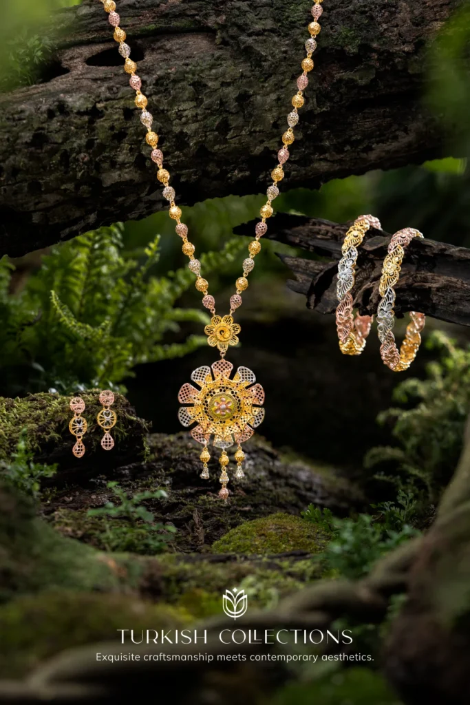 Gold Turkish necklace set with floral design, displayed on mossy wood.