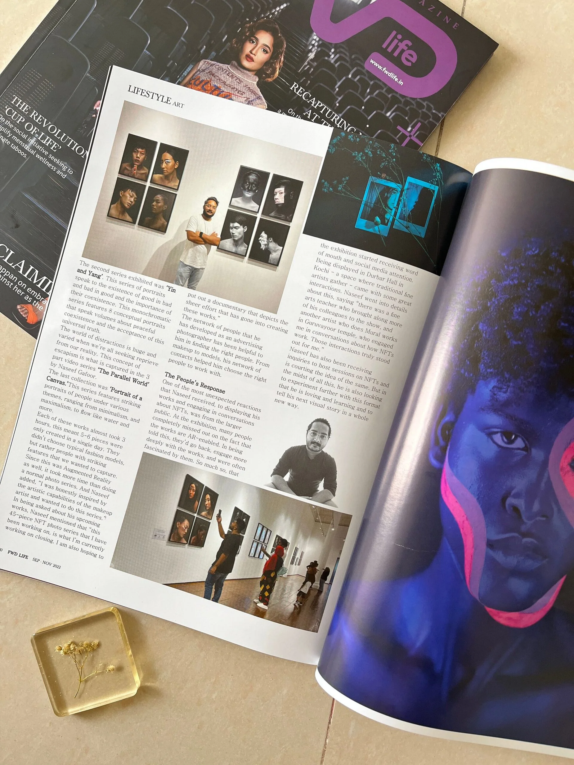 Magazine spread showing an art exhibition feature and a portrait with neon face paint.