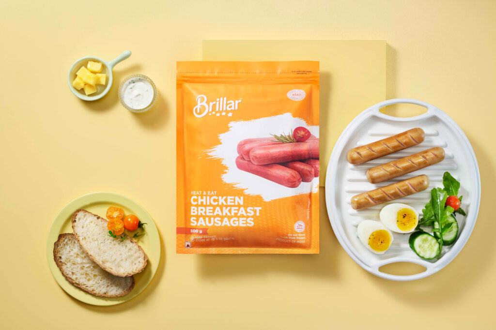 Chicken sausage pack with a plated breakfast spread.