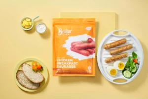 Chicken sausage pack with a plated breakfast spread.