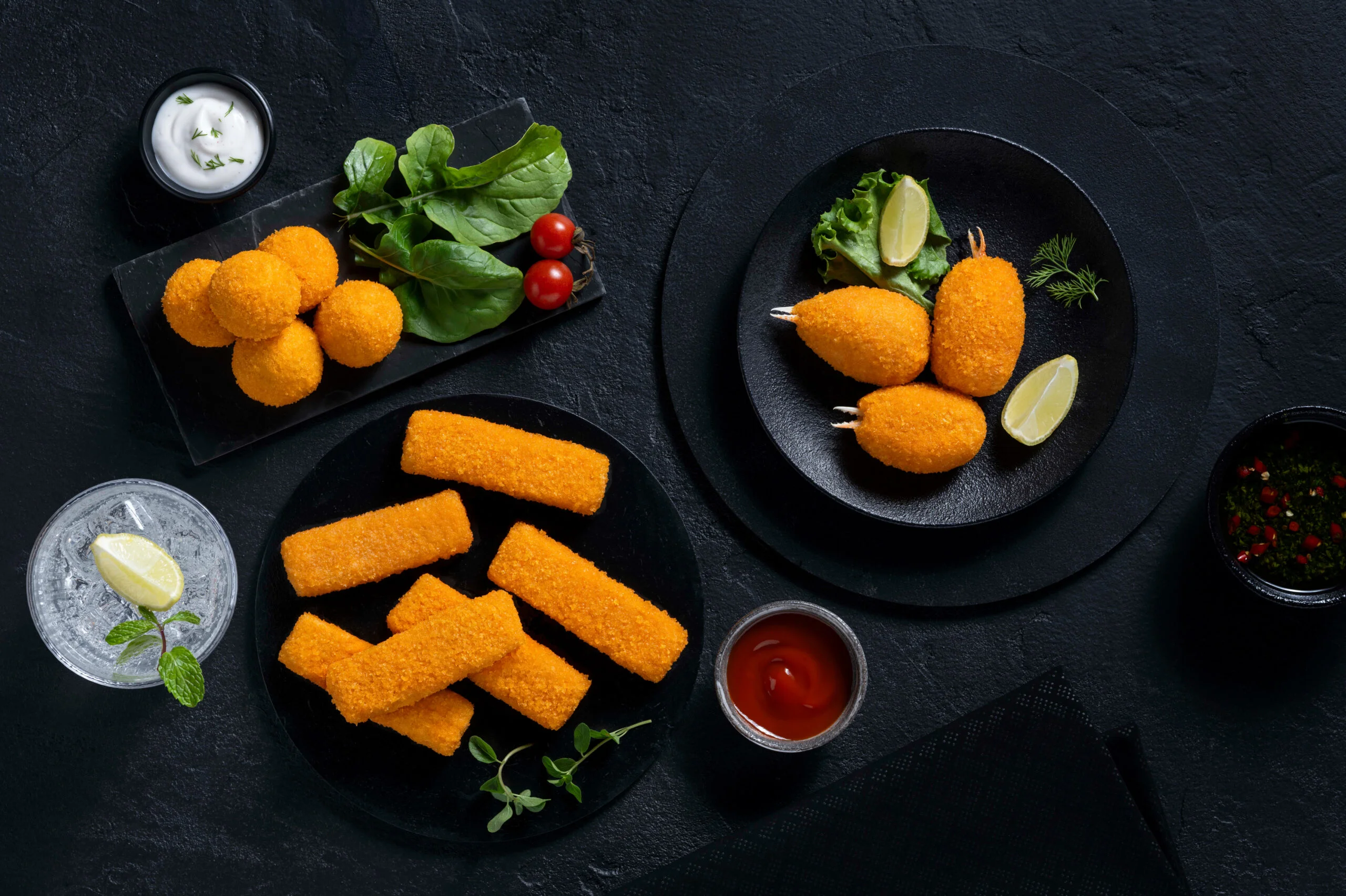 Assorted crispy fried snacks served with dips.