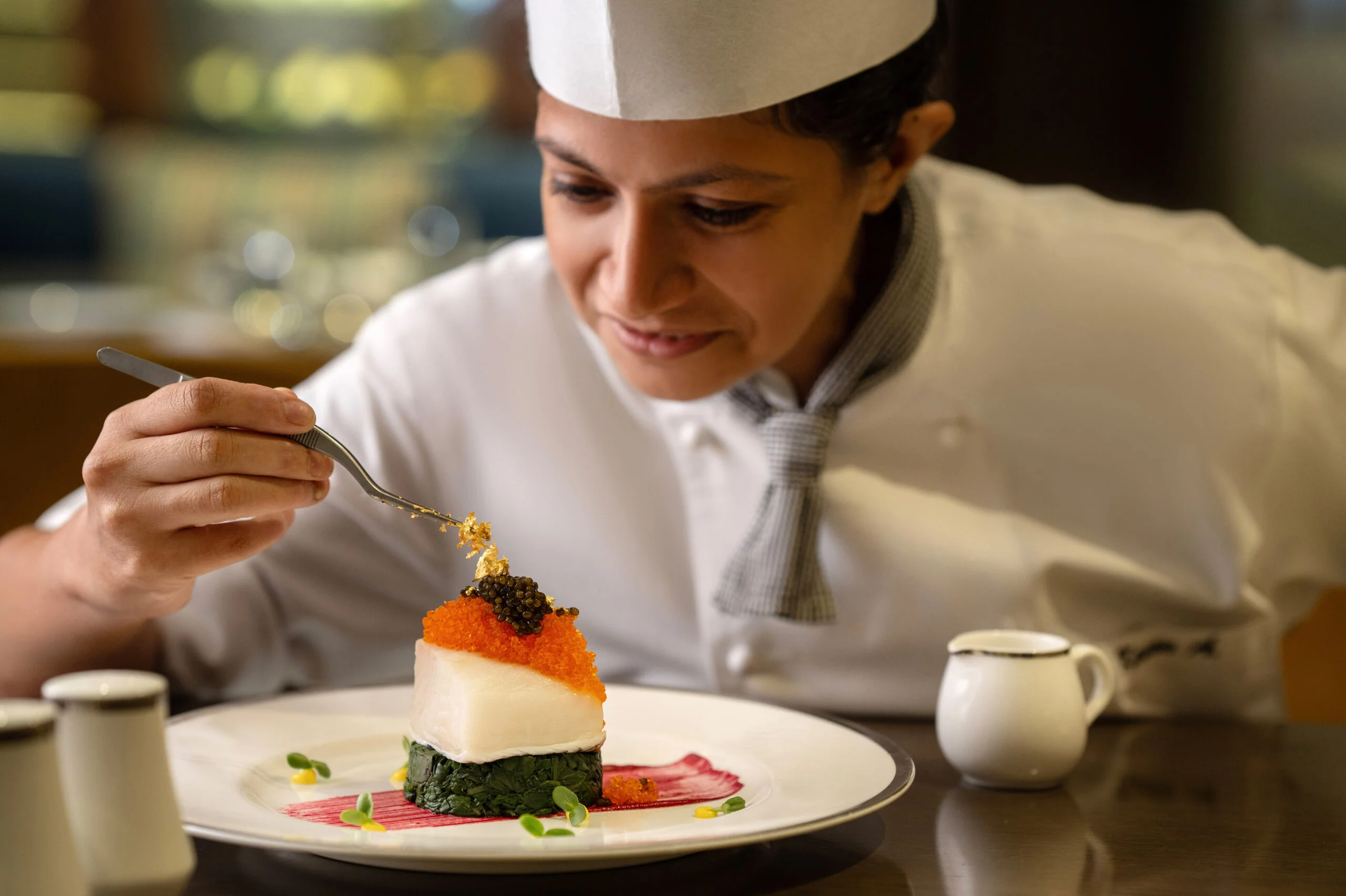 Chef plating a gourmet dish.