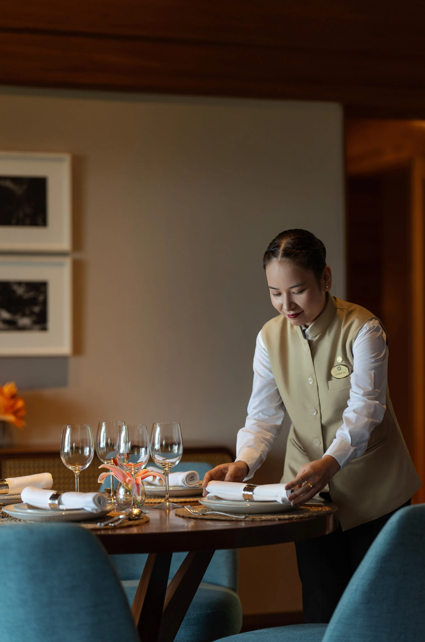 Staff member setting a fine-dining table