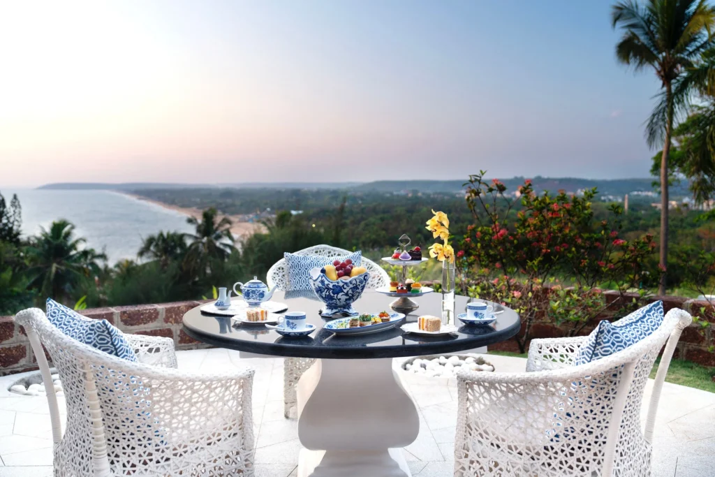 Luxury seaside dining with elegant tableware and a tranquil coastal view.